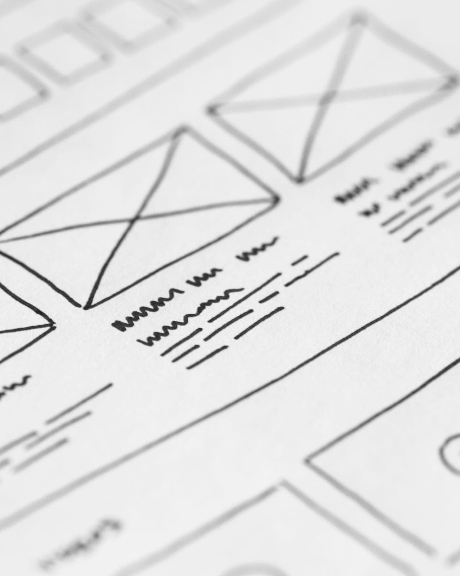 Website pages sketched on paper